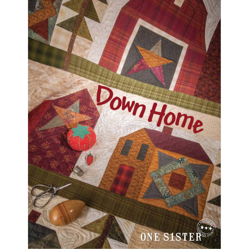 Cover of a quilt pattern book titled Down Home featuring colorful quilt blocks with house and star designs. Scissors and a wooden spool are placed at the bottom, along with a small red tomato pin cushion. The text One Sister is displayed at the bottom.