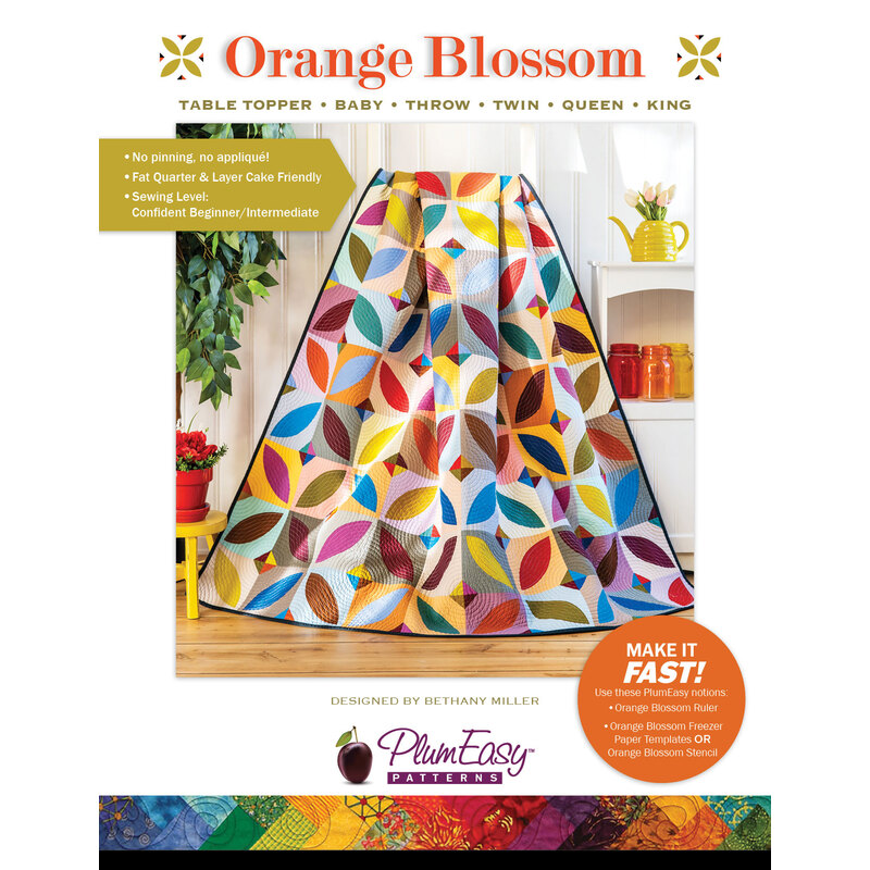 front cover of Orange Blossom Quilt pattern with a sample quilt draped stylishly, showing the finished design 