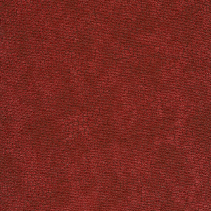 mottled cranberry red fabric with a tonal cracked earth pattern