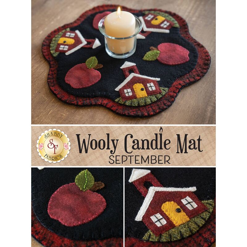 A round black candle mat featuring appliqué designs of red apples and a small house with a red door. A white candle is placed in the center. The text at the bottom reads Wooly Candle Mat SEPTEMBER.