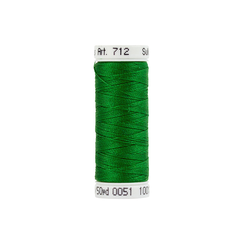 Green sewing thread on a spool with a white label showing thread info and size.