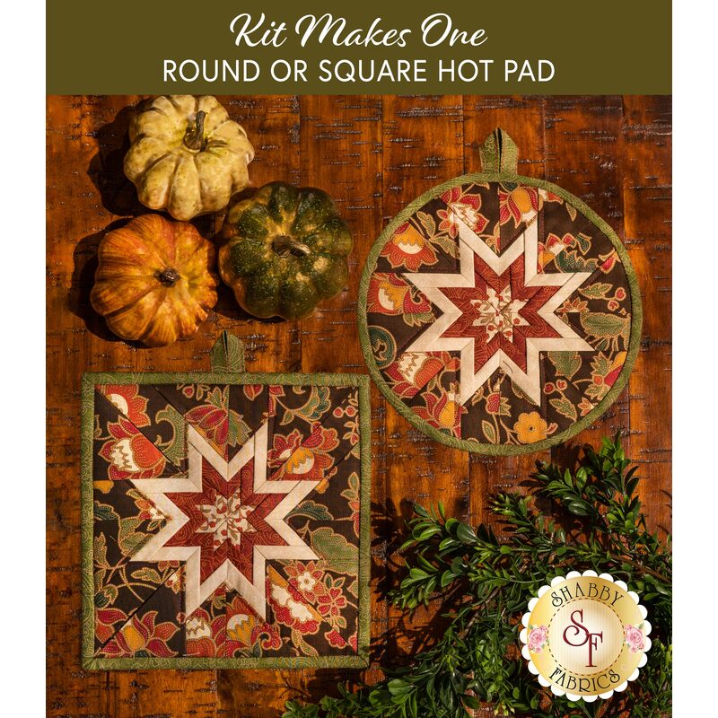 Two autumn themed floral hot pads with a central folded star design on wooden table next to small pumpkins.