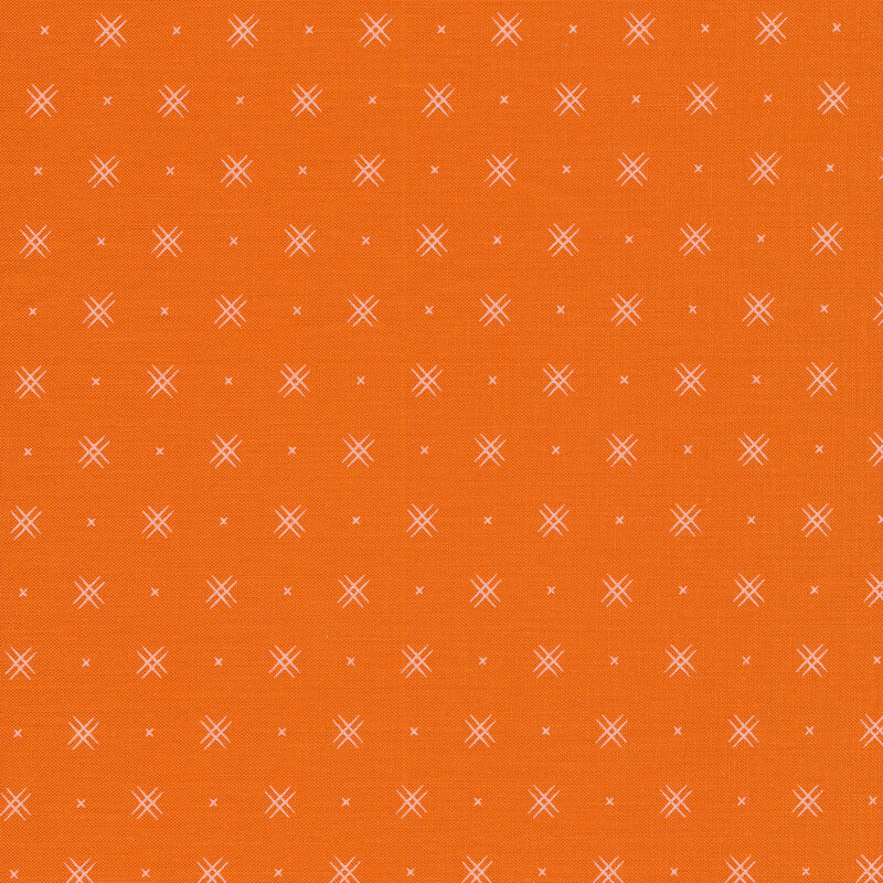 Orange fabric with rows of small white x's and double criss-cross patterns