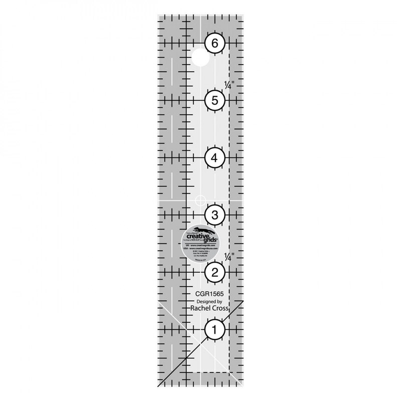 Clear acrylic ruler with measurement markings from 1 to 6 inches and a circular hanging hole at the top.