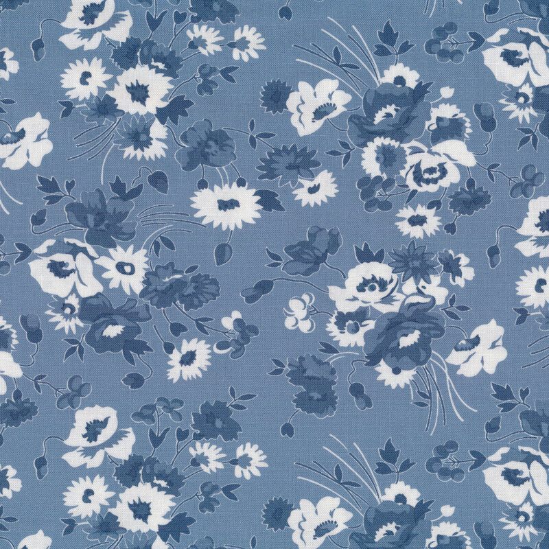 Fabric with blue and white floral bunches tossed on a medium blue background