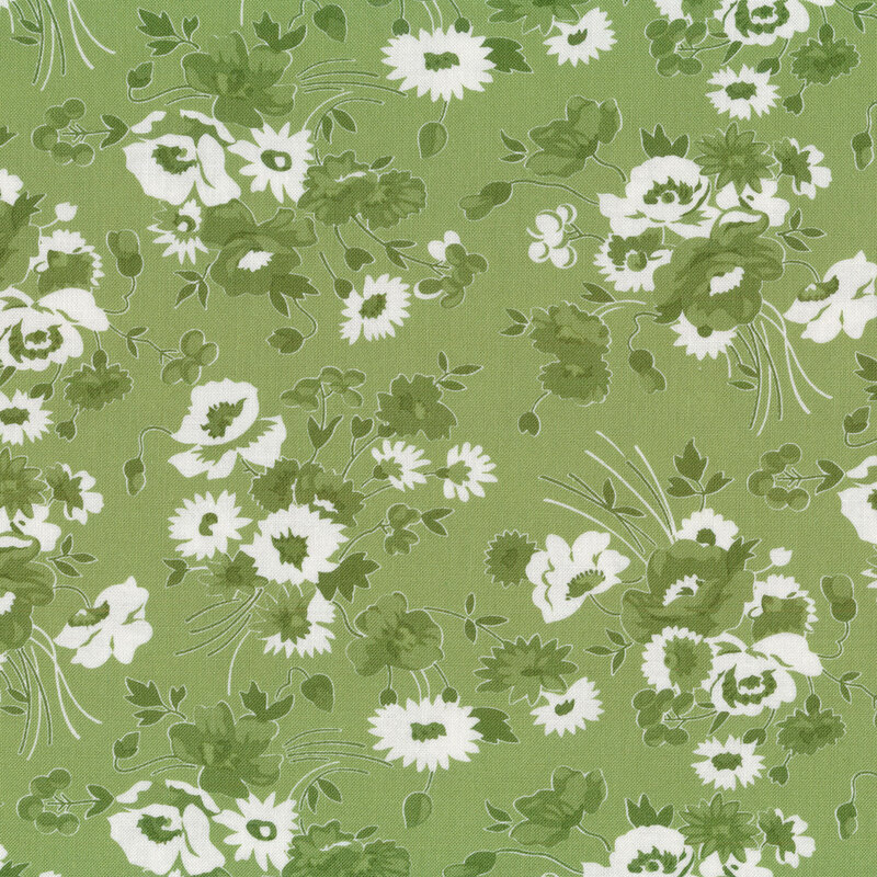 Fabric with green and white floral bunches tossed on a medium green background