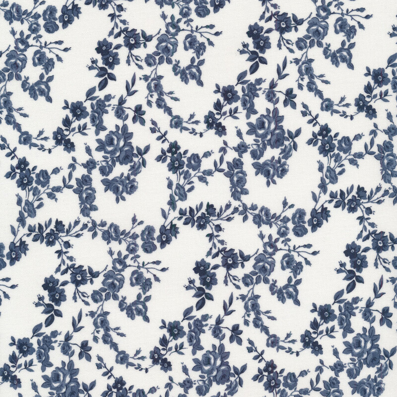 Fabric with navy blue floral vines all over a cream background