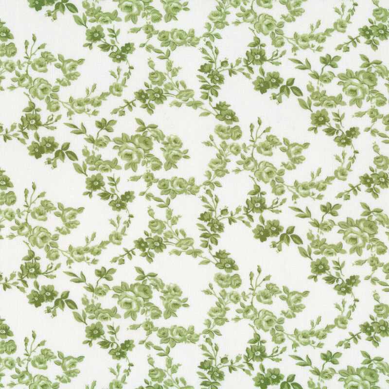 Fabric with green floral vines all over a cream background