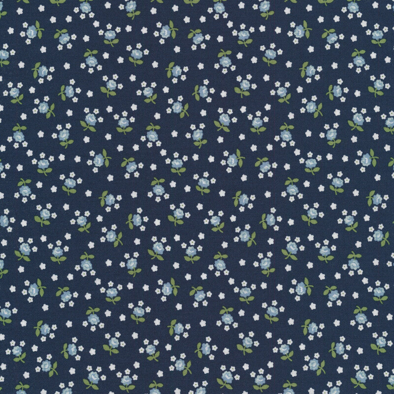 Fabric with tossed white and light blue flowers on a dark navy background.