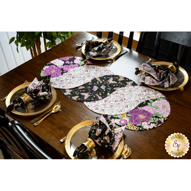 Braided twist being used as table runner on table set with plates and cloth napkins.
