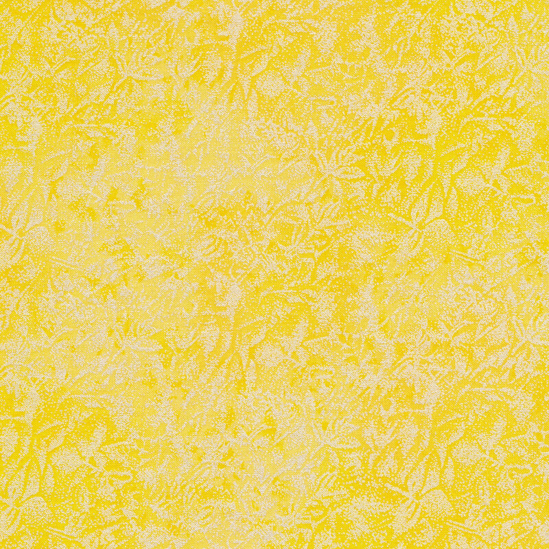 Tonal yellow colored fabric features mottled design with metallic accents