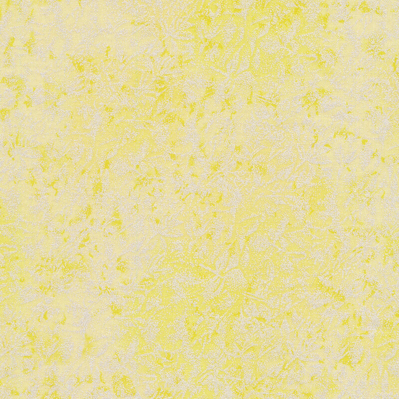 Tonal light yellow colored fabric features mottled design with metallic accents