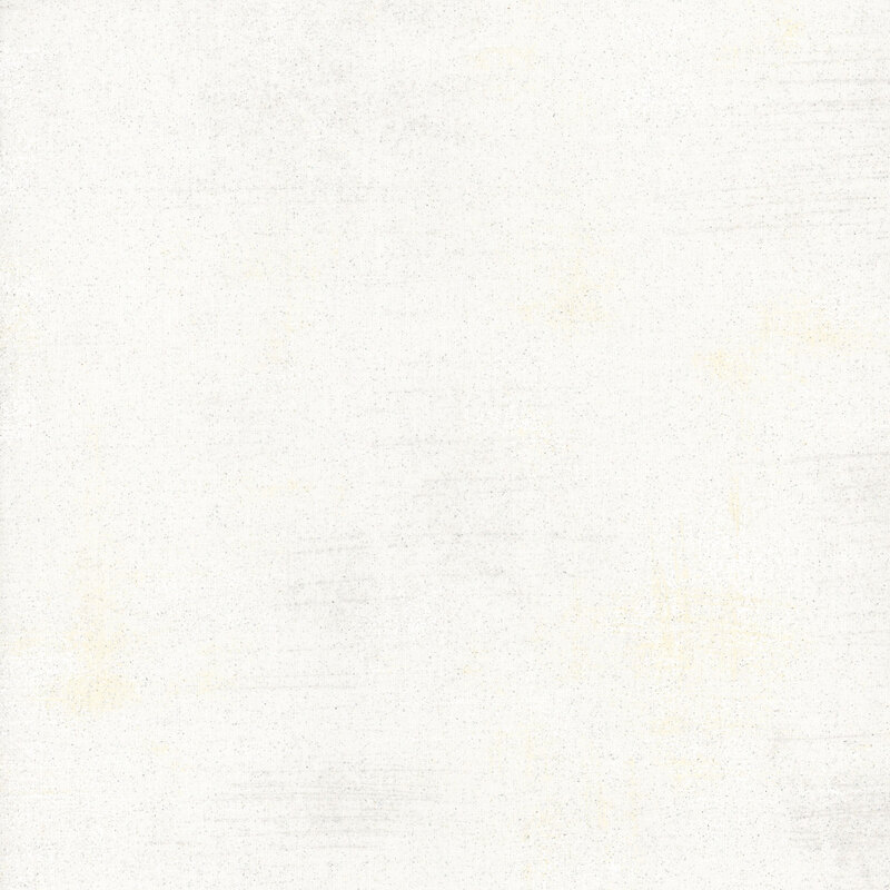 Mottled white grunge textured fabric with tiny specks of glitter