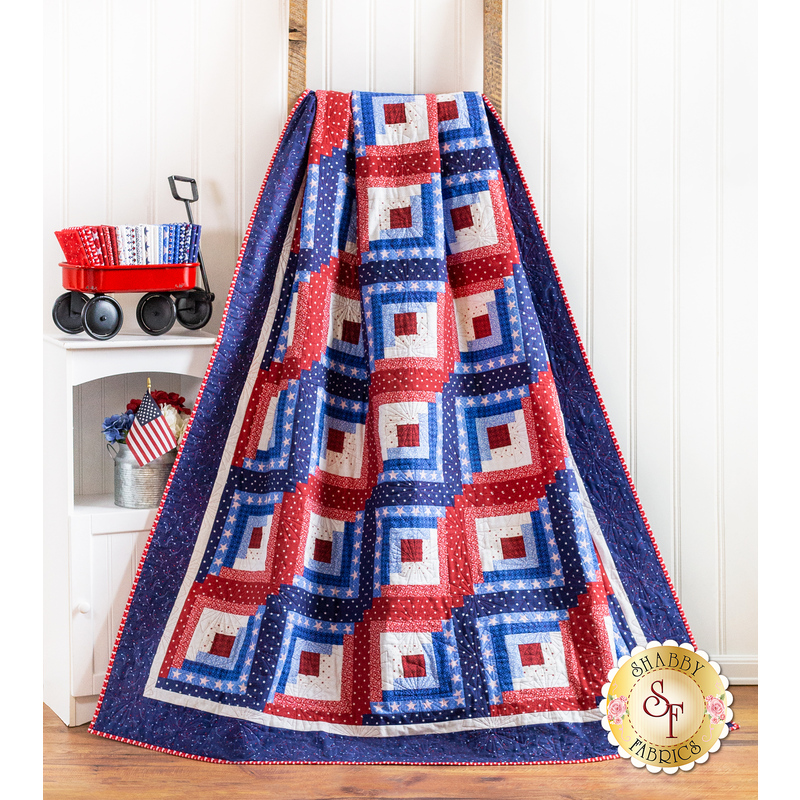 Americana themed quilt draped over furniture.