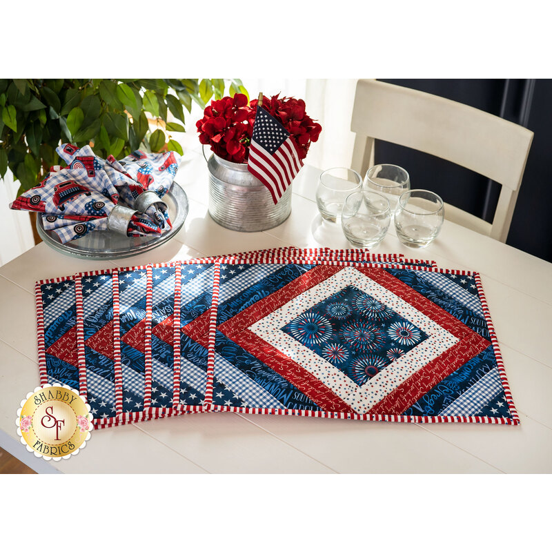 Placemats made of strips of patriotic printed red, white, and blue strips of fabric in a diamond design.