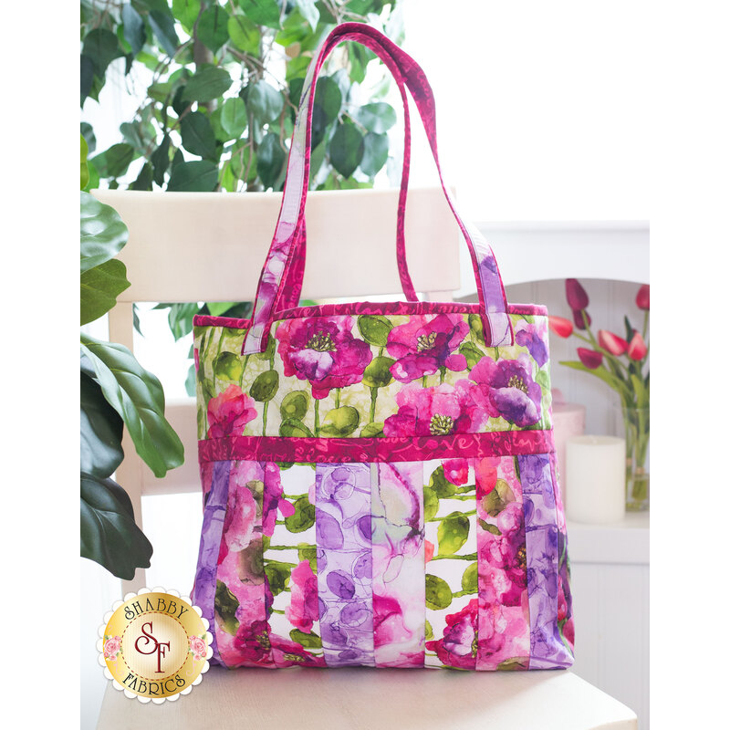 Tote bag made of strips of bright colorful floral printed fabrics in a watercolor style.