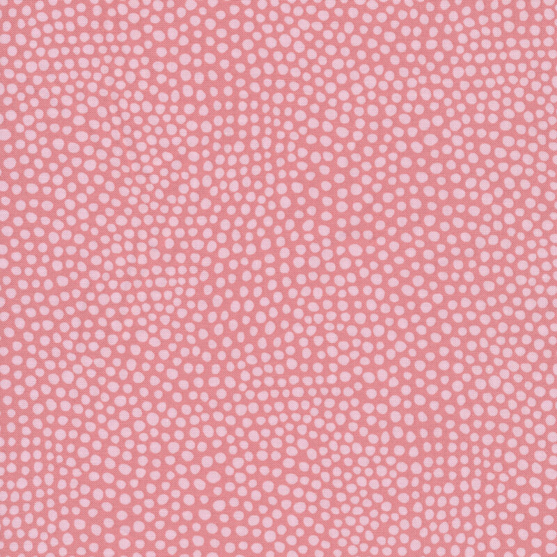 Tonal pink fabric with light pink polka dots all over a pink background