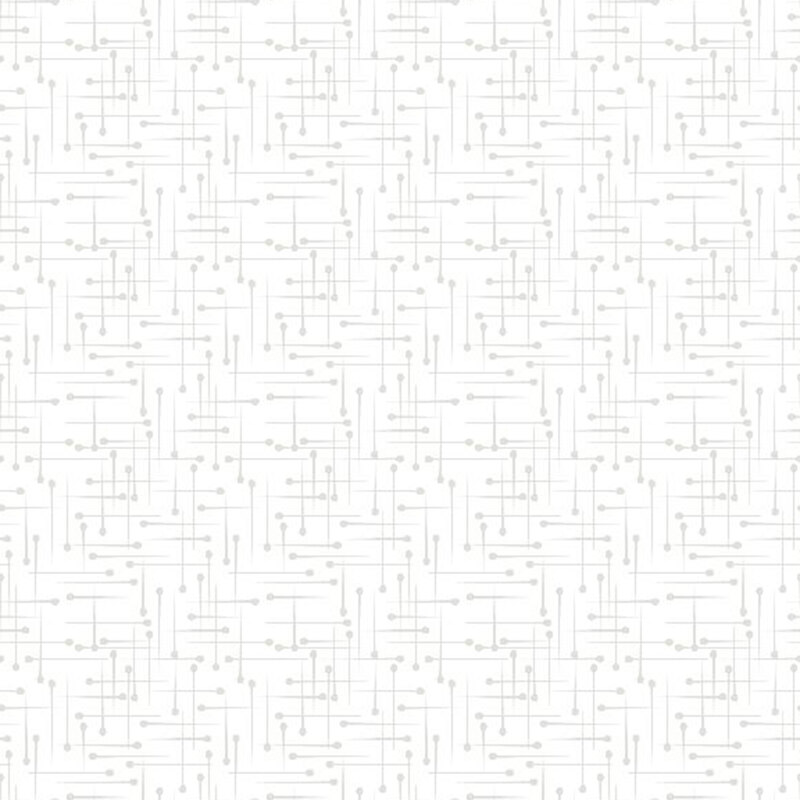 light grey pins all over a white fabric background.