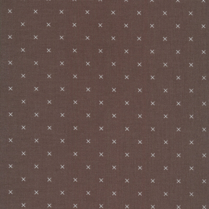 Small cream x's on a brown background