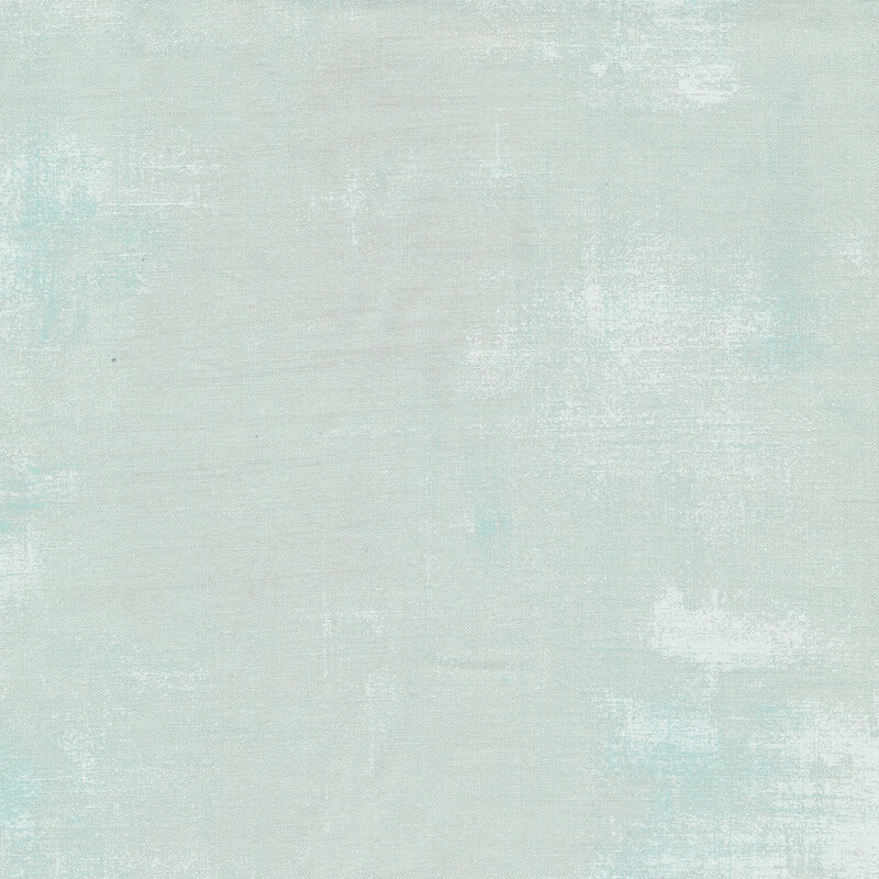 A pale aqua grunge textured fabric