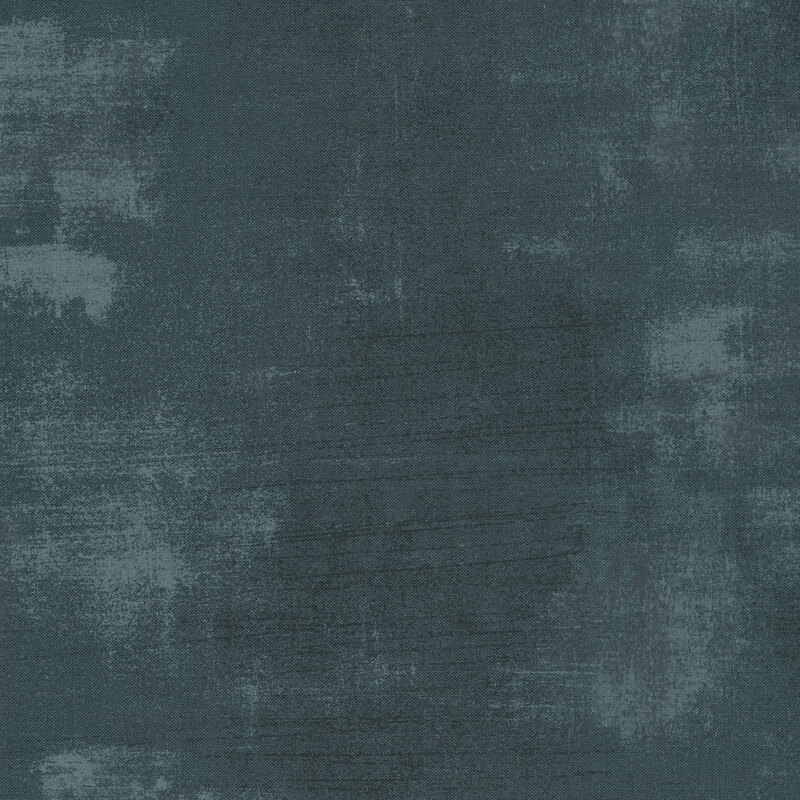 A dark blue fabric with bits of pale blue grunge texturing