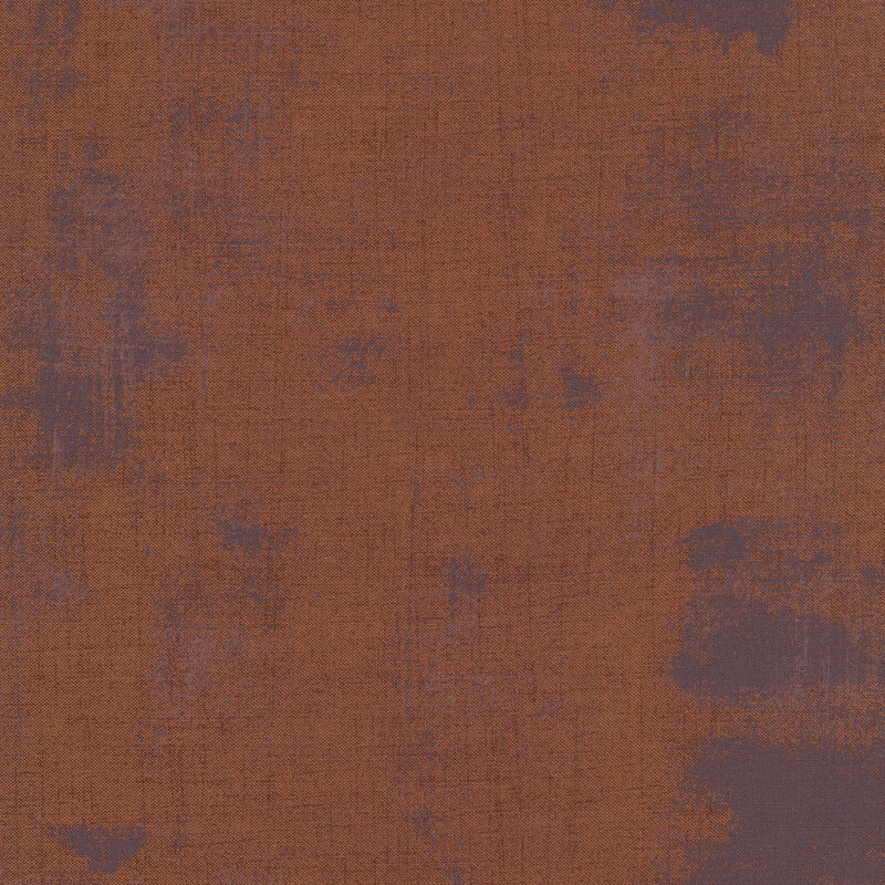 A dark brown fabric with grey grunge texturing