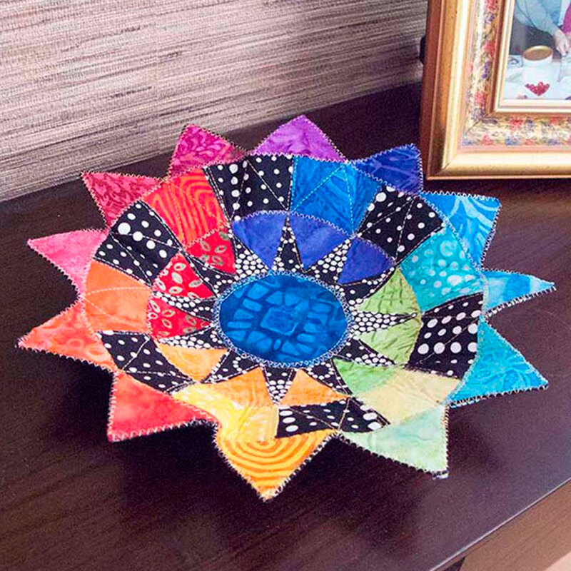 Photo of finished fabric bowl made of multicolored fabrics in a geometric design