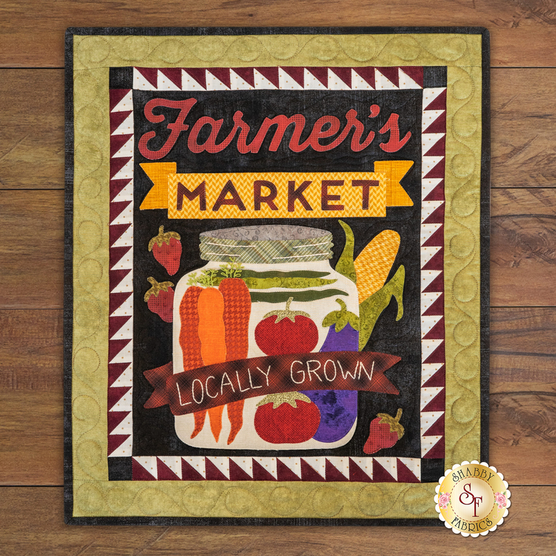 A decorative sign featuring the words Farmer's Market in bold, colorful lettering at the top, with illustrations of fresh vegetables, including carrots, tomatoes, and corn. The phrase Locally Grown is prominently displayed on a banner at the bottom. The background has a textured pattern with a quilt-like border.