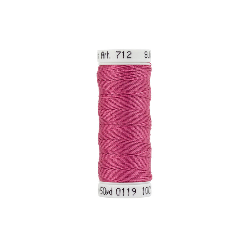 Pink sewing thread on a spool with a white label displaying color and product details.