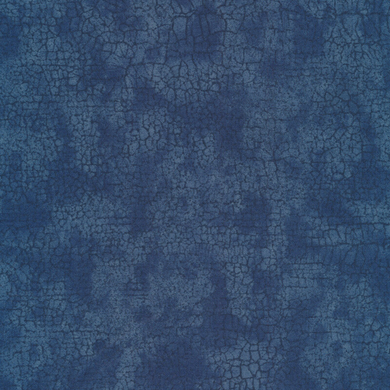 Mottled tonal blue fabric features crackle texture design