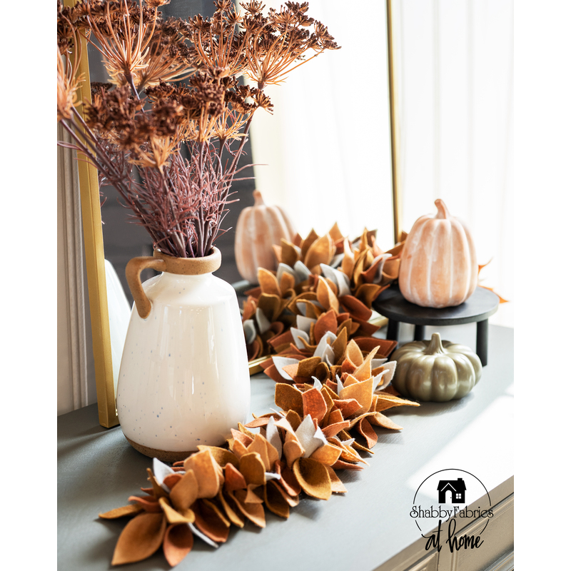 leaf themed centerpiece made with autumn colors and felt leaves.