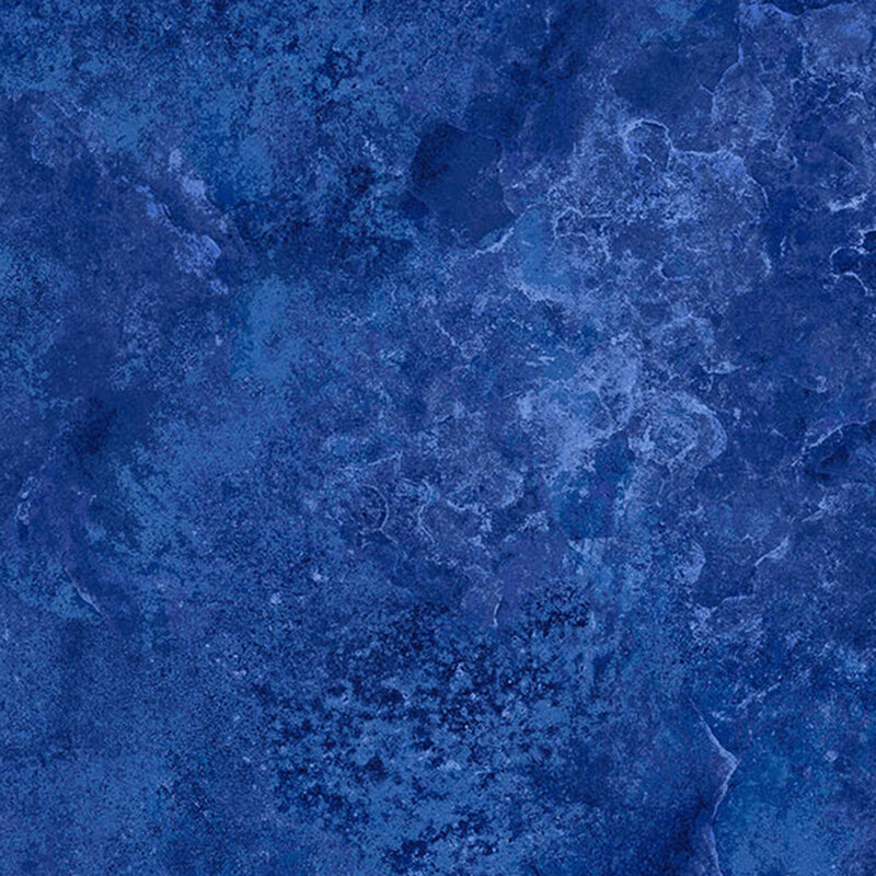 A tonal medium blue marbled fabric with a concrete texture look