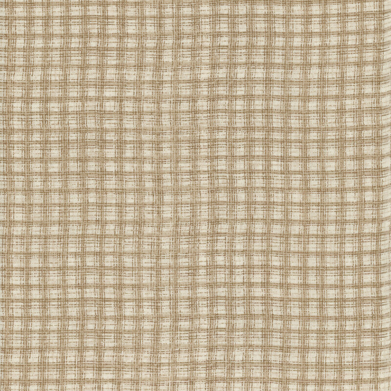 This fabric features a lovely dark tonal tan plaid print