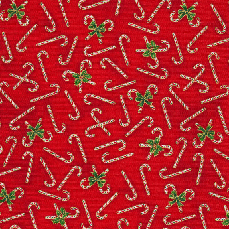 Christmas red fabric with featuring candy canes and small holly leaves with gold metallic accents