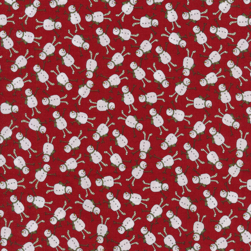 A red Christmas fabric covered in tossed joyful snowmen wearing little green scarves