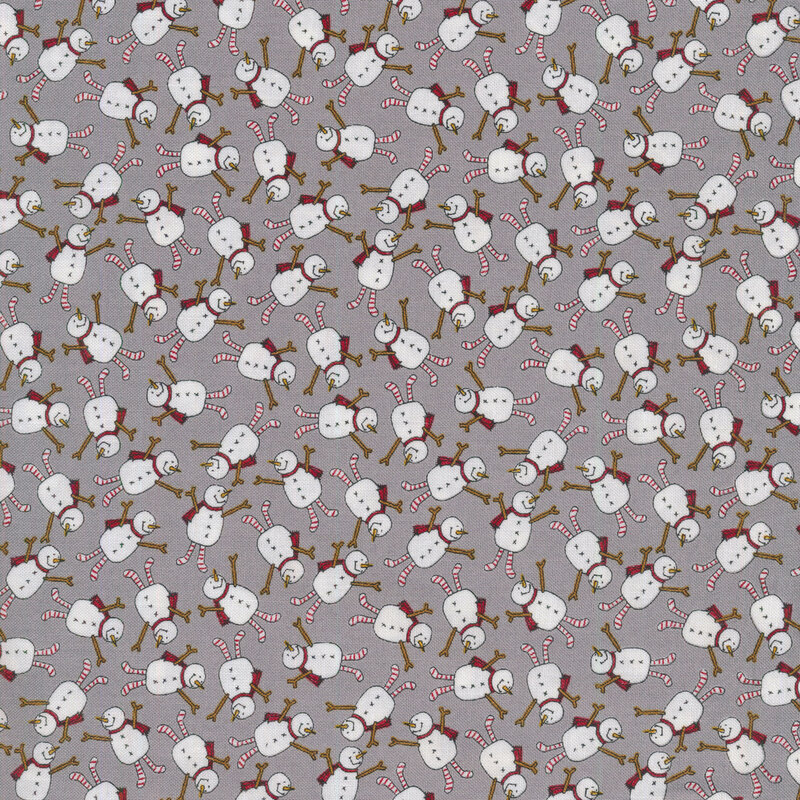 A medium gray Christmas fabric covered in tossed joyful snowmen with little red scarves