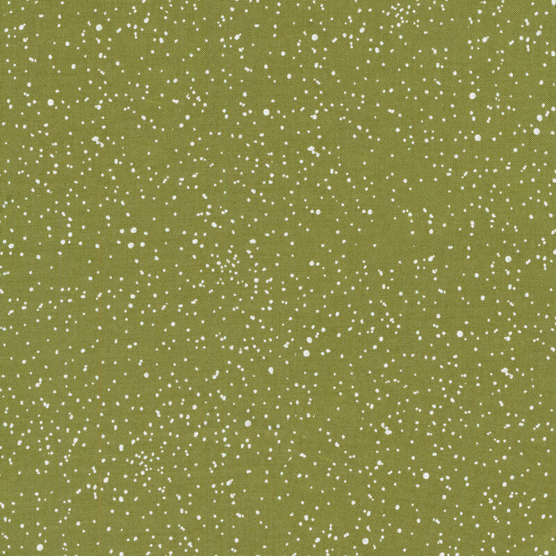 Green sewing fabric with scattered white snowflake dots all over