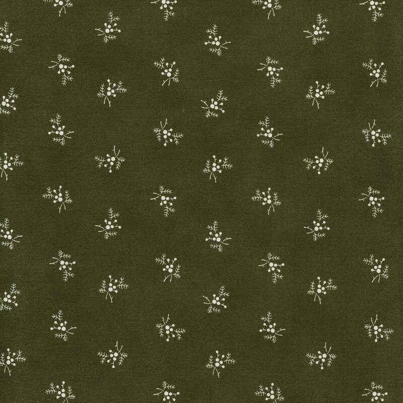 cream holly sprigs tossed on a dark green background