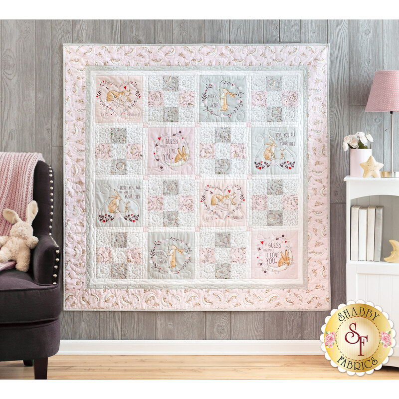 Photo of a cream, pink, and grey quilt that features rabbits from the children's book, 