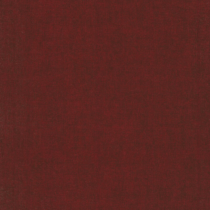 Solid tonal dark red fabric with mottling all over