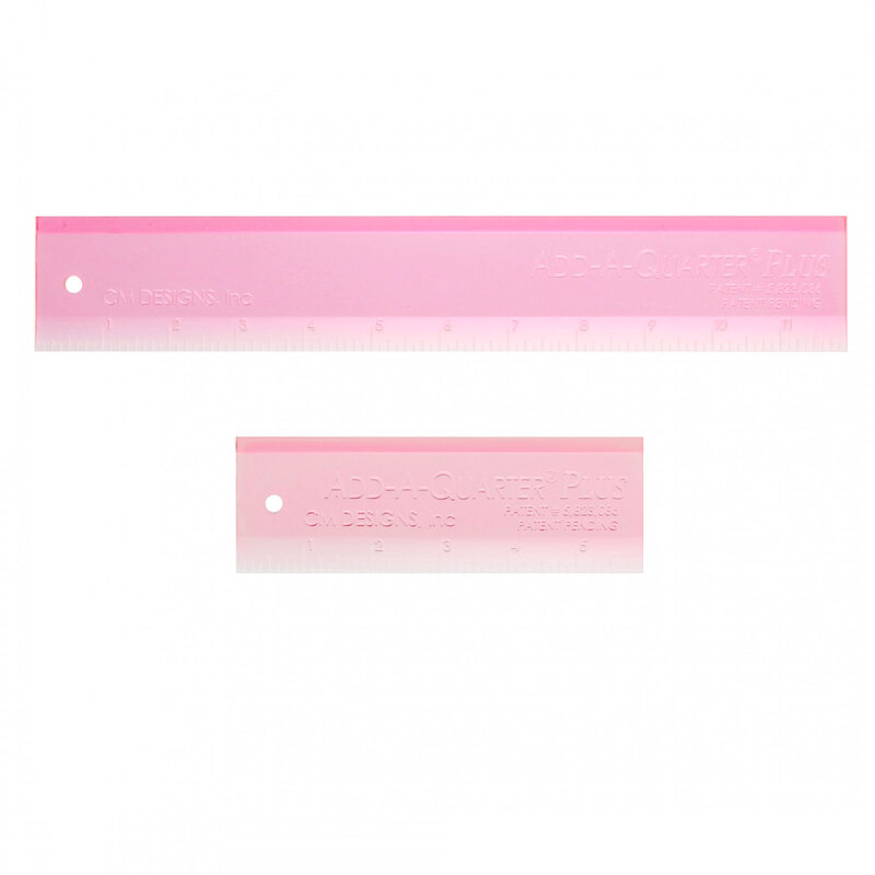 Two pink plastic rulers, one larger and one smaller, both featuring measurement markings and holes.