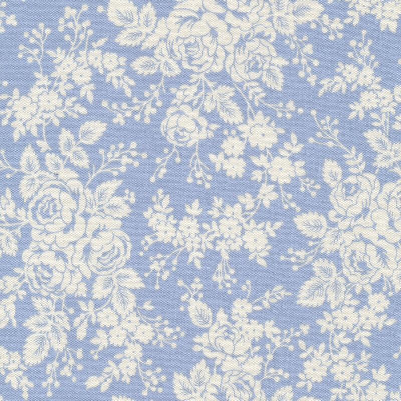 White roses and floral bunches on a light dusty blue fabric