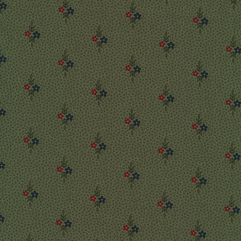 Fabric that features small motifs of red and dark blue flowers with sprigs of leaves on a dark green background.