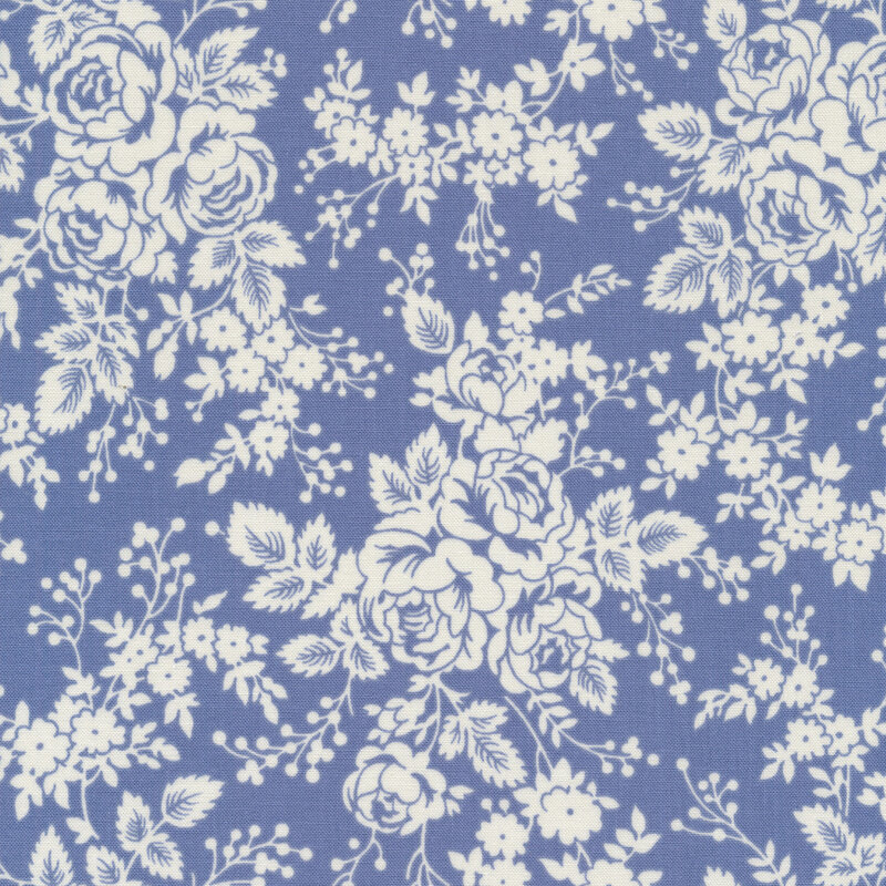 White roses and floral bunches on a medium dusty blue fabric