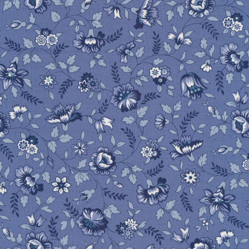 medium blue fabric features a variety of spring flowers from roses to daffodils and daisies in alternating shades of cream and dark blue