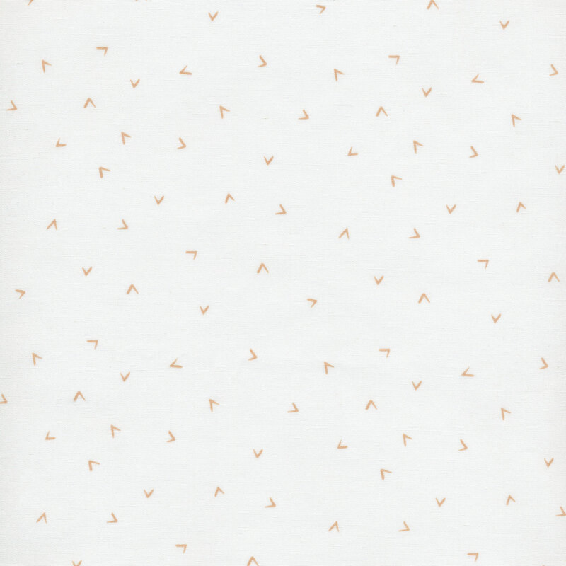 fabric featuring gold ditsy tossed chevrons across an off white background