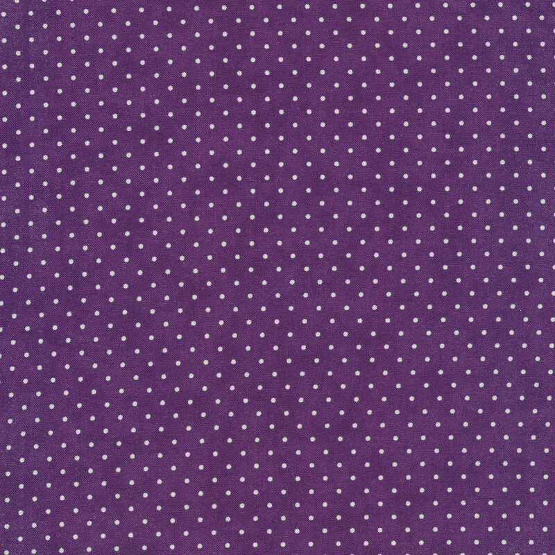 Eggplant purple fabric with small white polka dots throughout