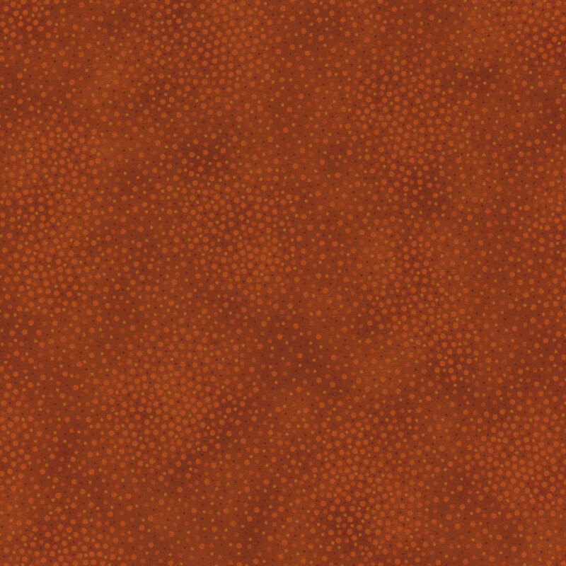 Tonal burnt orange fabric with meandering dots and spots all over a mottled background