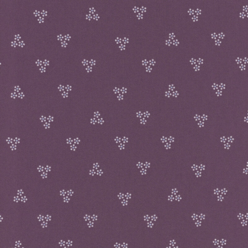 This fabric features floral cluster motifs in cream on a purple background.