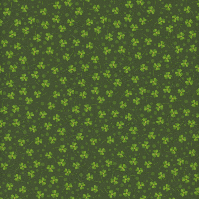 Fabric with tiny scattered green shamrocks and metallic accents at the center